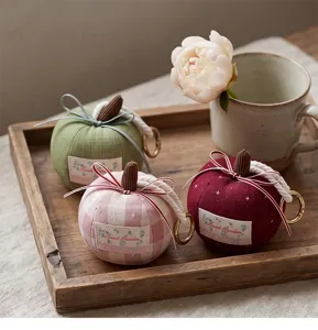 Cute fabric bow pumpkin keychain detail, elegant car hanging pendant and accessory display.