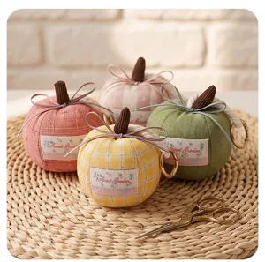 Cute fabric pumpkin pendant keychain with bow and sweet garden label for car interior decor.