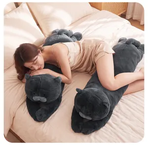 Detail view of a long grey cat plush body pillow on a cozy bed, soft and cute for sleeping.