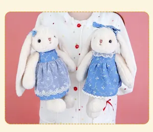Cute Easter long ear plush bunny doll with blue floral dress and bow hair accessories.
