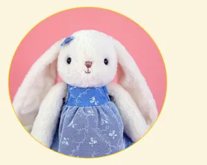 Detailed view of the cute long-eared plush bunny doll wearing a sweet blue floral dress.