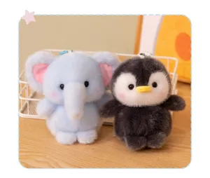 Cute plush animal keychain detail featuring soft elephant and penguin dolls in a storage basket.