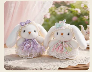 Detailed shot of cute Lolita style plush bunny toys in lace dresses with lovely butterfly bows.