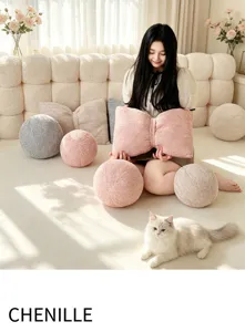 Cozy chenille bow pillow and round cushion detail shot for warm living room decor cozy feel