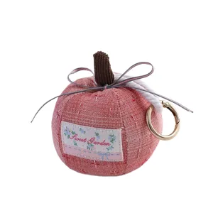 Cute fabric apple keychain with bow and metal ring, perfect for car rearview mirror decor.
