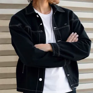 Detailansicht der schwarzen Herren-Jeansjacke mit stilvollen weißen Kontrastnähten und Knöpfen.