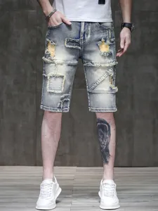 Summer distressed denim shorts for men, light wash vintage street style elastic shorts.