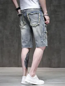 Back view detail of men's light wash distressed denim shorts showing frayed pocket design.