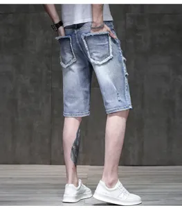 Men's light blue distressed denim shorts detail, retro street style stretchy five-quarter pants.