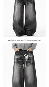 Detailed view of dark grey washed distressed baggy denim jeans, casual streetwear style.