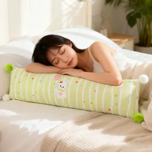 Cute striped long bolster pillow with rabbit print and pom-pom decor for cozy sleeping.