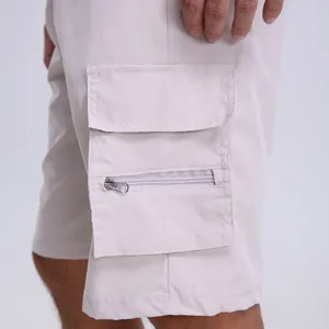 Men's casual cargo shorts detail view, featuring multi-pockets and a zippered pocket in beige.