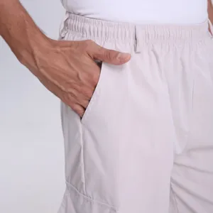 Detail shot of men's casual cargo shorts pocket and elastic waistband in off-white summer style.