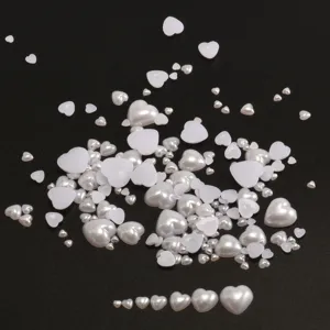 Detail shot of multi-size heart flat-back pearl patches, ABS imitation beads for DIY crafts.