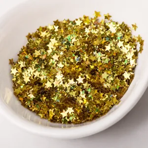 Detail shot of golden star glitter flakes in white bowl for nail art and DIY craft decor.