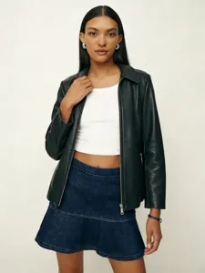 Detailed view of women's fashion outfit featuring black leather jacket and denim mini skirt.