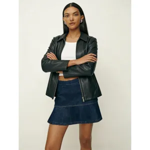 Women's fashion outfit featuring black faux leather jacket and casual denim skirt.