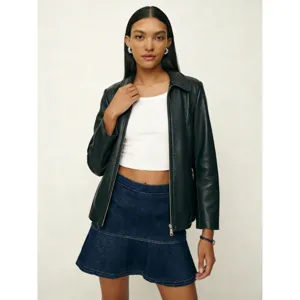 Stylish women's fashion detail view showcasing trendy outerwear and casual tiered denim skirt.
