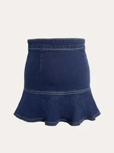 Blue denim fabric skirt detail showing contrast white stitching and ruffle hem design.