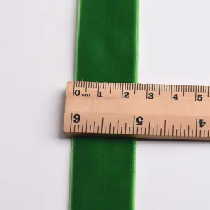 Green velvet ribbon detail shot showing width measurement for DIY craft bow Christmas decoration.