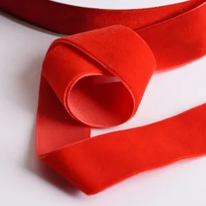 Red velvet ribbon detail shot, soft texture fabric ribbon for DIY crafts, bows and holiday decor.