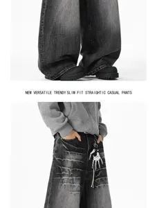 Detailed view of washed black distressed baggy denim jeans, showcasing streetwear casual style.