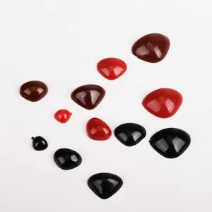 Close-up detail of plastic triangle safety eyes and noses for DIY plush toys and dolls crafting.