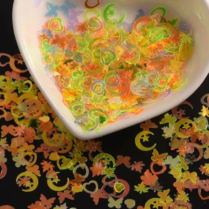 Close-up detail of colorful holographic nail art sequins, star heart butterfly shapes glitter.