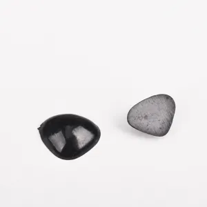Close up view of black triangle nose and eyes DIY accessories for crochet dolls crafts.