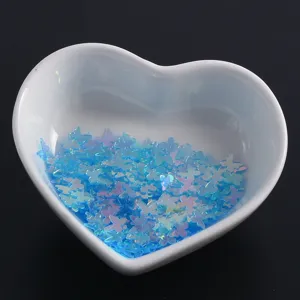Blue holographic butterfly nail sequins detail showing colorful sparkle flakes for DIY crafts.