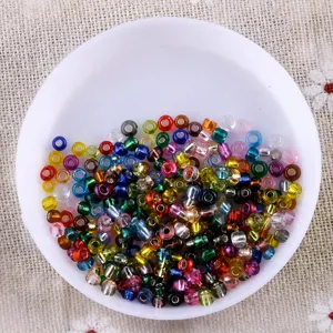 Detailed shot of colorful mixed glass seed beads in a white bowl for DIY handmade jewelry.