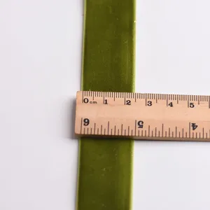 Green velvet ribbon width detail view showcasing texture and precise dimension measurement.