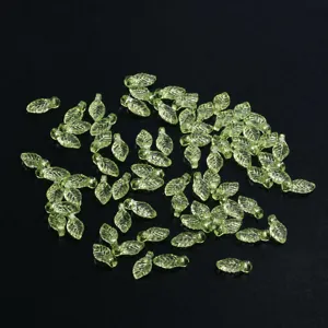 Detail shot of green leaf beads for DIY jewelry making, ideal for handmade necklaces and bracelets.