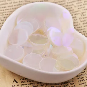 Close up detail of 15mm iridescent round sequins for DIY craft and clothing decoration use.