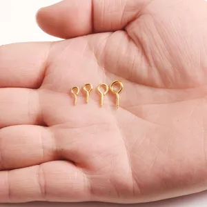 Gold screw eye pins close-up showing four sizes for handmade jewelry DIY craft projects.