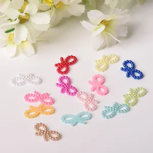 Close-up shot of colorful pearl bow DIY patches, perfect for phone case decoration.