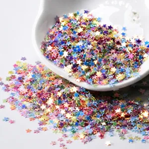 Detailed shot of 3mm colorful star sequins glitter for DIY epoxy resin and nail art crafts.