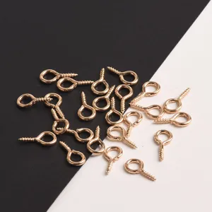 Gold screw eyes for DIY handmade jewelry craft accessory detailing closeup view display.
