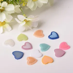 Close-up detail view of colorful heart resin pearl cabochons, perfect for DIY phone case crafts.