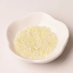 Close-up detail of 2mm cream glass seed beads, perfect for DIY handmade jewelry crafting.
