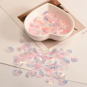 Detailed close-up shot of iridescent shell-shaped sequins for DIY crafts and clothing decor.