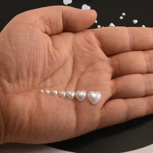 Multi-size heart flatback pearls for nail art and phone case DIY crafts, smooth glossy finish.