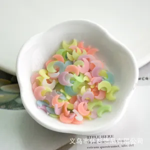 Close-up of colorful glow-in-the-dark moon resin DIY charms fillers for crafts and phone cases.