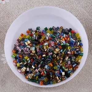 Colorful mixed bugle beads and seed beads close-up detail for DIY handmade jewelry bracelets.