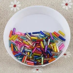 Colorful mixed bugle beads detail shot, perfect for DIY jewelry making and handmade crafts.