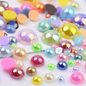 Close-up detail shot of colorful flatback half-round imitation pearls for DIY phone case crafts.