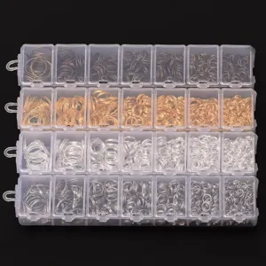 Close-up detail of assorted metal jump rings in a storage box for DIY jewelry making.