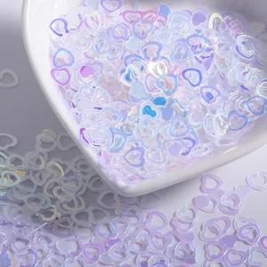 Iridescent holographic heart nail sequins, hollow and solid heart pieces for DIY nail art decor.