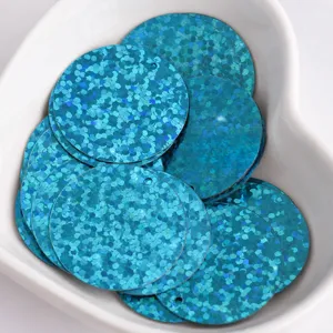Close-up of 25mm blue holographic round sequin paillettes with side hole for DIY crafts and clothing.