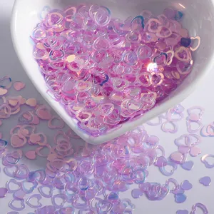 Iridescent pink heart nail sequins, holographic glitter confetti for DIY craft art and makeup decoration.